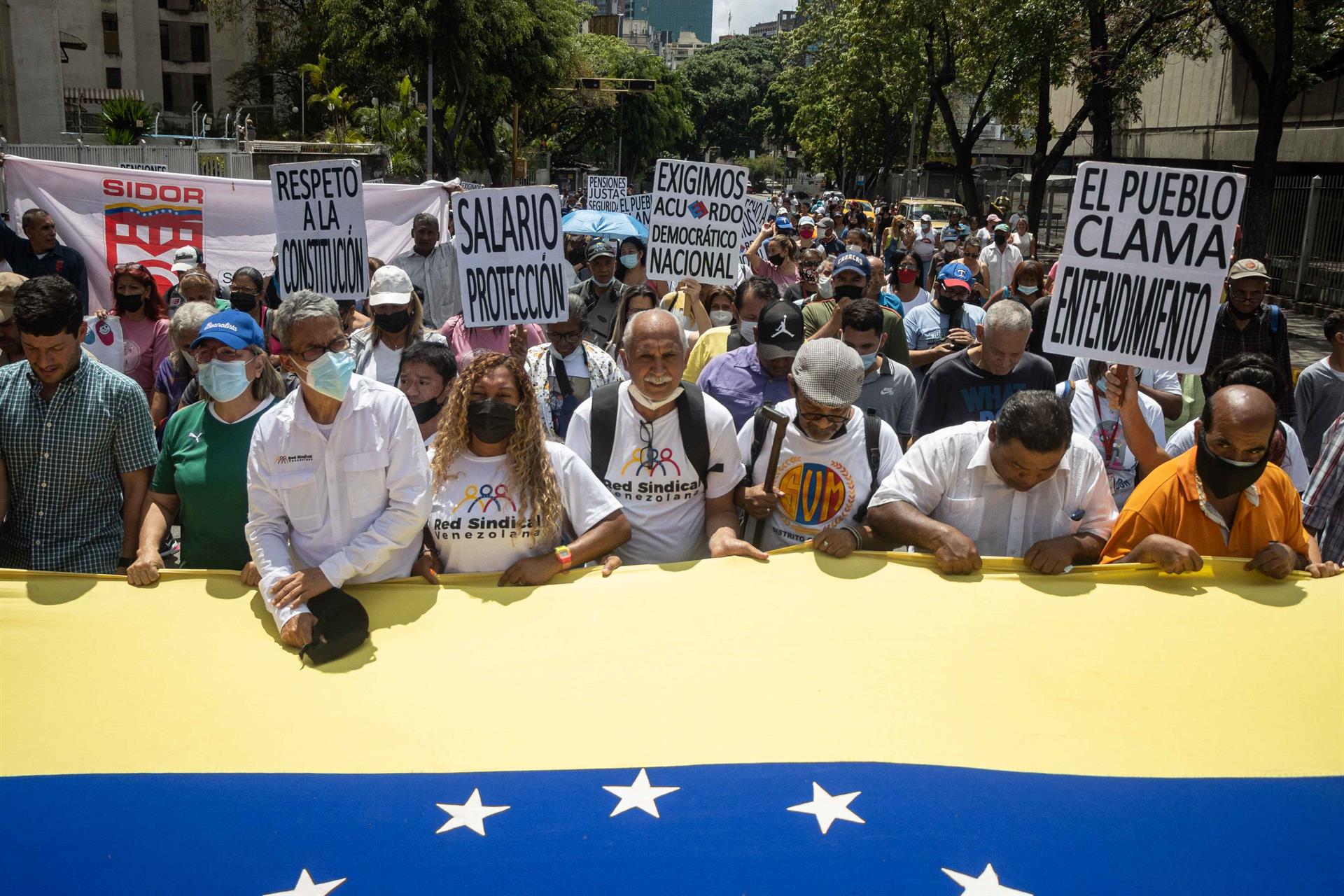 Manifestantes participan en una marcha para exigir mejoras salariales y beneficios durante el Día Internacional del Trabajo en Caracas. Foto: EFE/ Ronald Peña