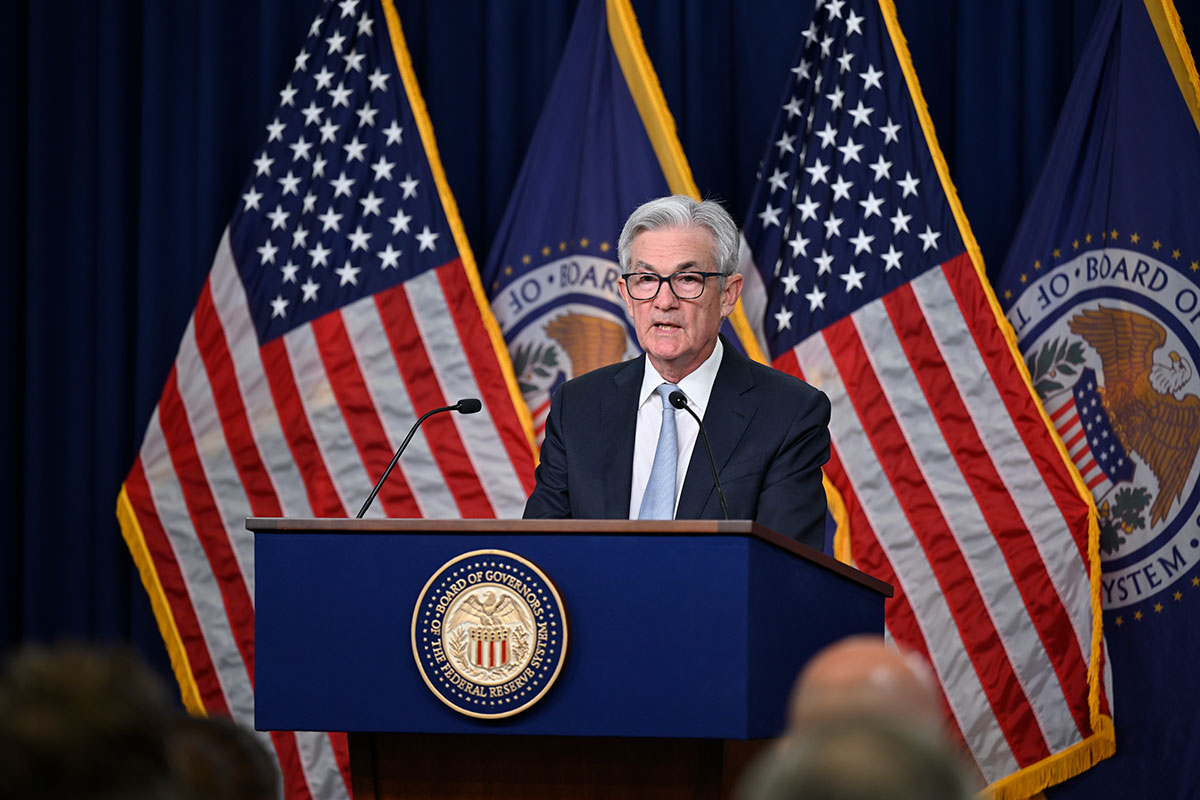 El presidente de la Reserva Federal (FED, en inglés) de Estados Unidos, Jerome Powell, responde a las preguntas de los periodistas detrás de un podio con el sello del Consejo de Gobernadores frente a un fondo azul con banderas estadounidenses y banderas con sellos del Consejo de Gobernadores. Foto: Twitter @federalreserve.